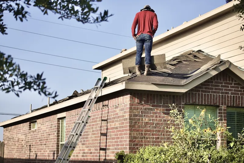 Professional roofer working on a residential roof in Wilmington